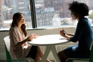 A woman talking with her translator colleague
