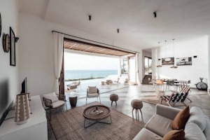 Modern open-concept living room with furniture and a stunning ocean view in Jamaica